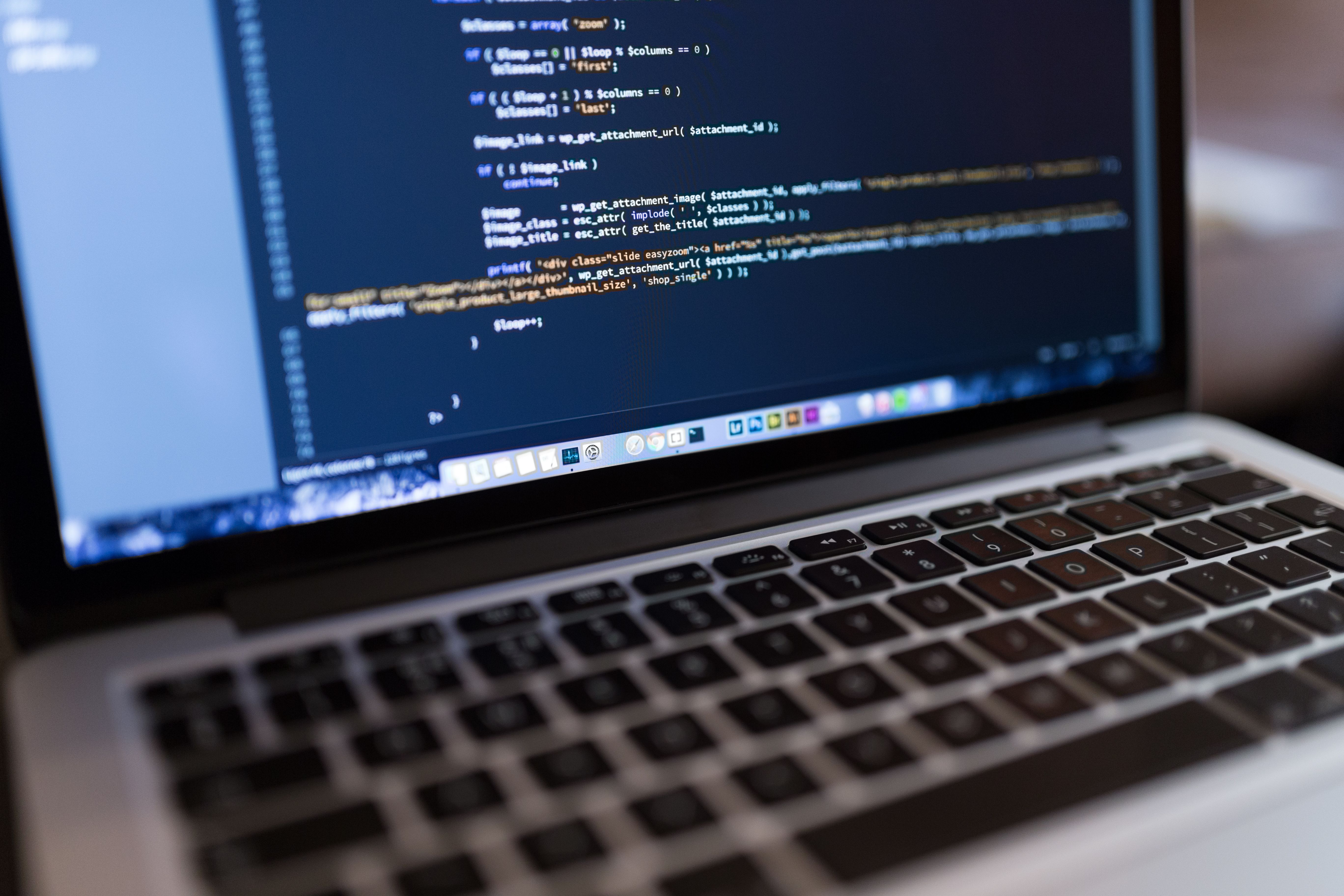 Freelance web developer working on client projects on a laptop
