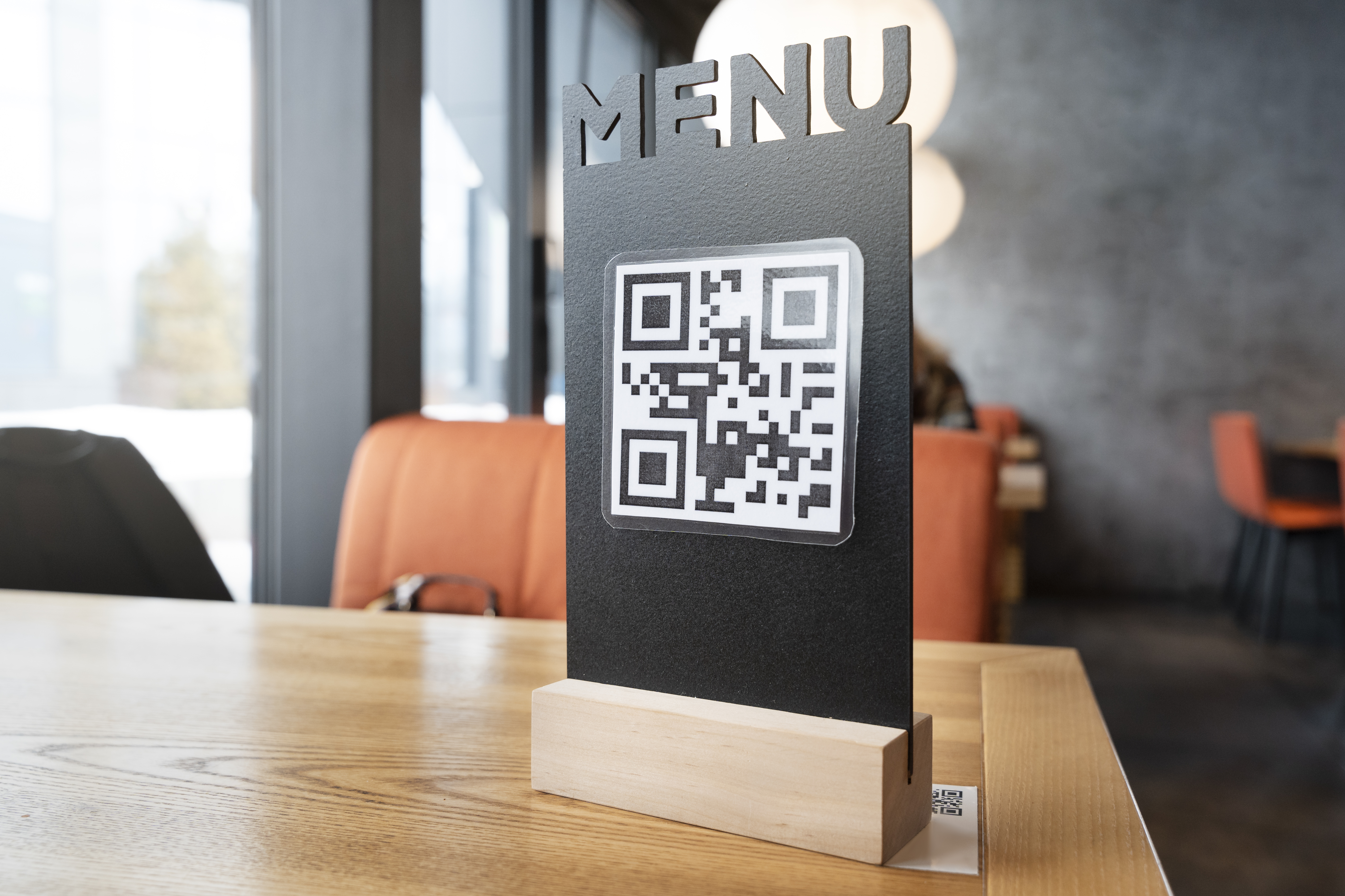 Restaurant table set for dining with a QR code menu option